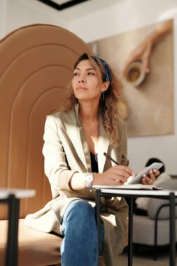 Young woman looking off camera pensively, used to explain the answers to the question do mammograms hurt