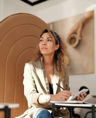 Young woman looking off camera pensively, used to explain the answers to the question do mammograms hurt