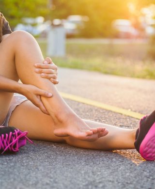 Woman holding leg, used to explain a muscle strain or tear