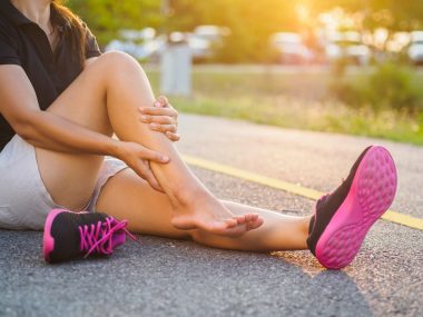 Woman holding leg, used to explain a muscle strain or tear