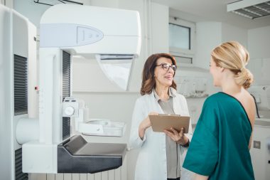Woman,oncologist,talking,with,her,patient,on,mammography,examination.