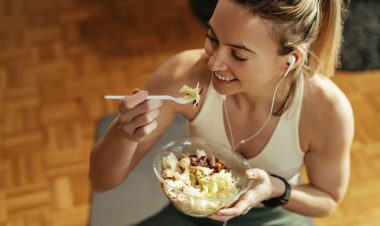 Image of woman eating in activewear, used to explain diet exercise and breast cancer risk