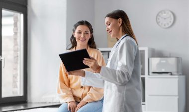 Stock photo of a female physician and a patient looking at a tablet, used to explain finding a mammogram imaging provider