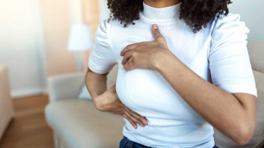 Image of a woman performing a breast self-exam