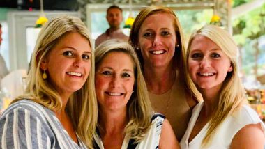 Bev Rowell and her daughters photographed smiling at the camera