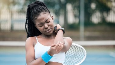 Young tennis player holding her elbow, used to explain sports injuries