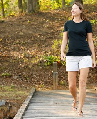 Woman walking on a dock, used to explain how to get rid of varicose veins